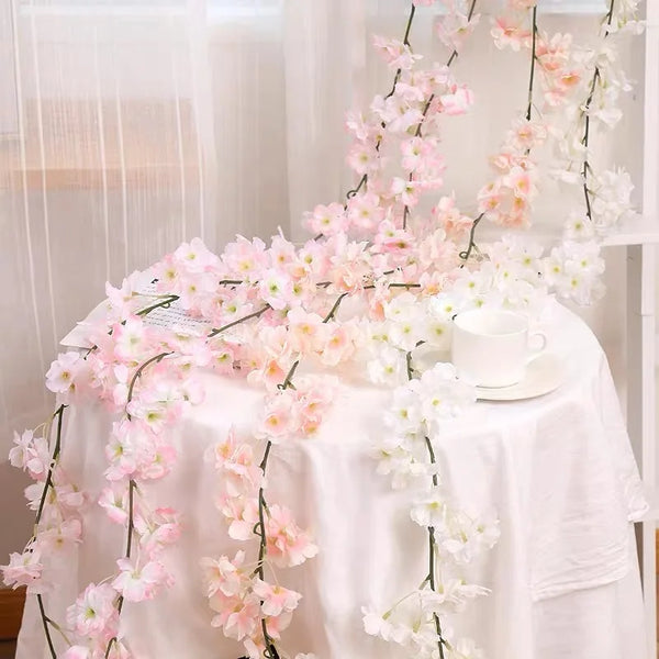 Pink sakura flower garland draped on a white tablecloth for weddings and events