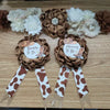 A set of floral maternity sashes and corsage pins featuring brown and cream flowers and brown ribbon with white spots.