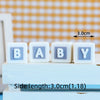 White wooden letters spelling BABY arranged in a row on a light blue surface