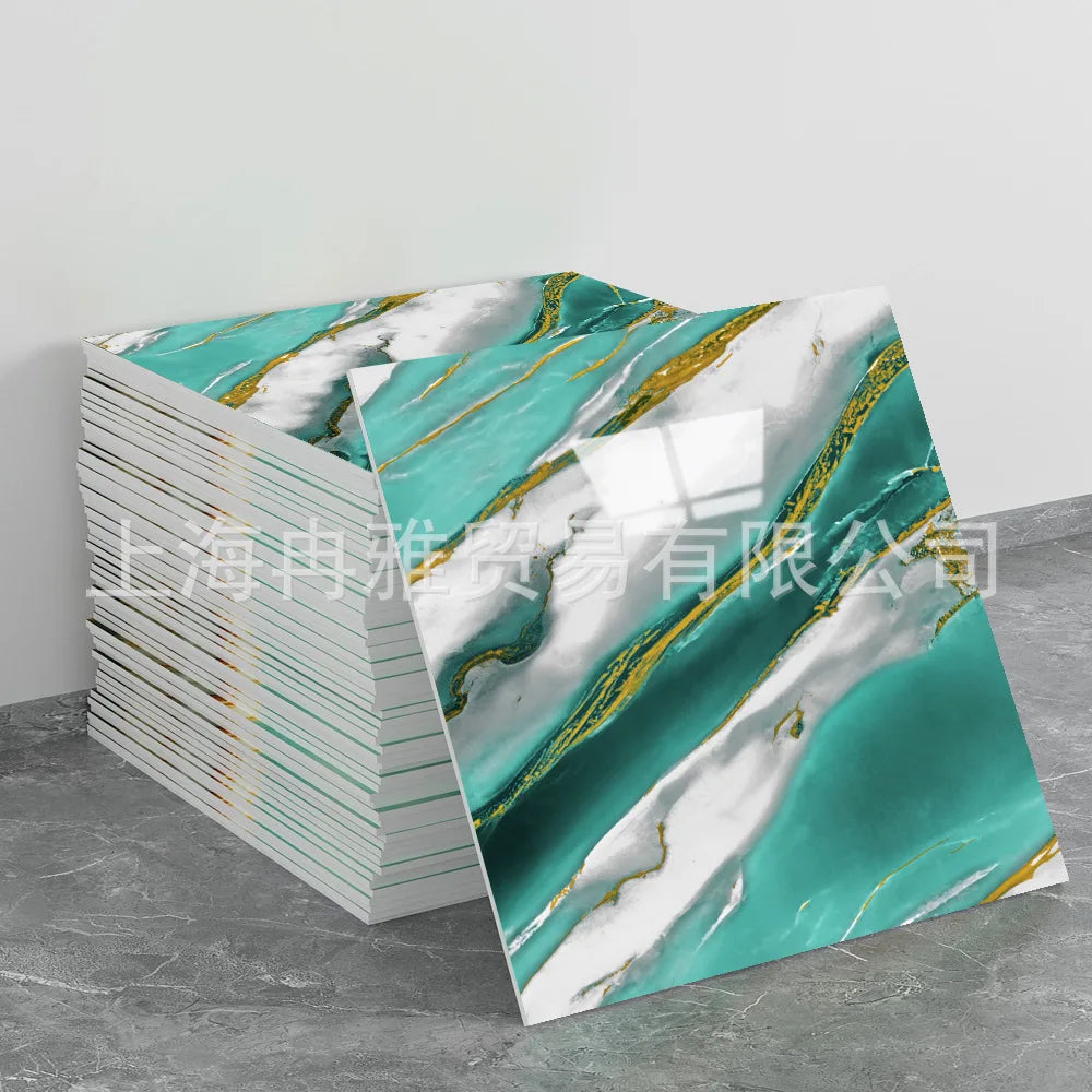 A stack of faux marble 3D self-adhesive wall tiles featuring teal and white marble patterns with gold veining.