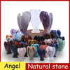 A collection of hand-carved angel crystal figurines in various shades of purple and green natural stone.