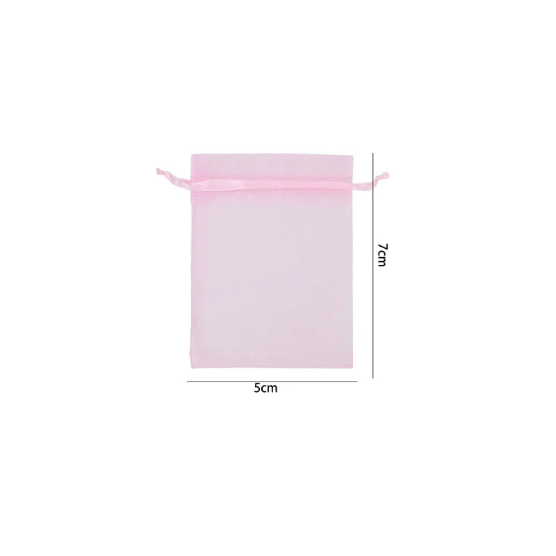 Pink organza drawstring gift bag with a pink cord and dimensions of 7cm by 5cm.