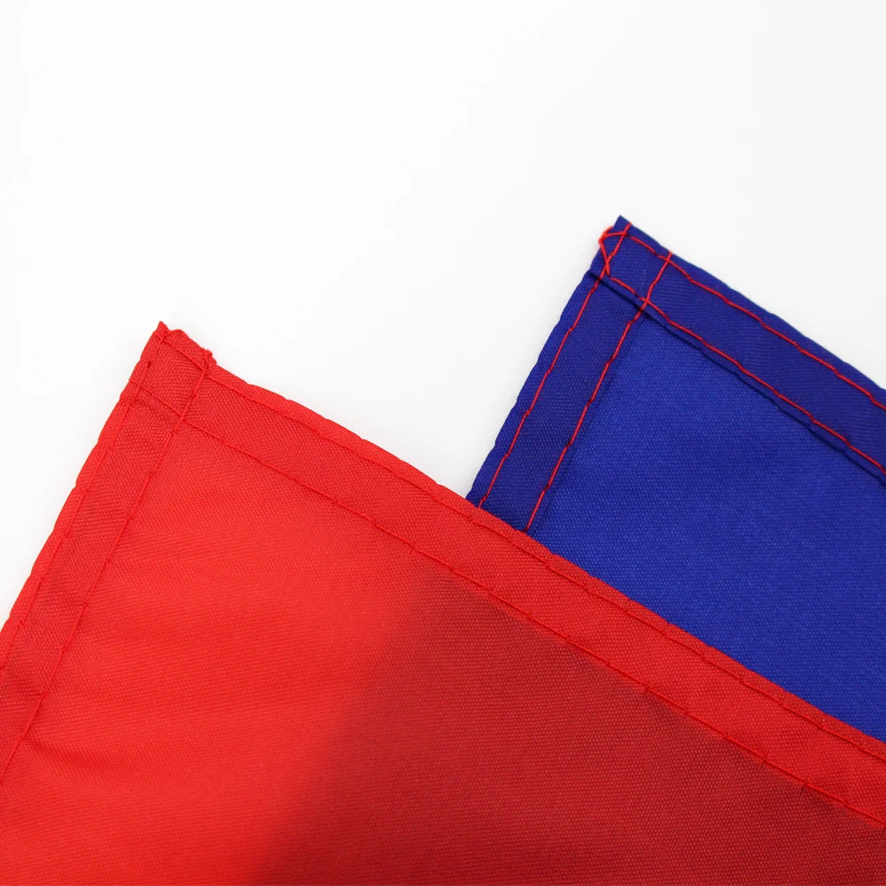 A close-up of a red fabric banner edge next to a blue fabric banner edge.