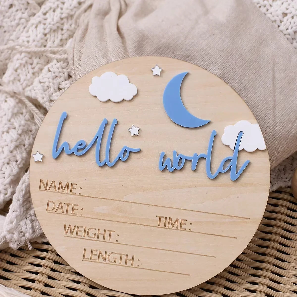A wooden birth announcement sign with the words hello world and blank lines for name date time weight and length, decorated w