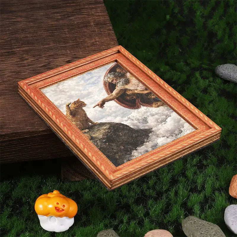 A framed art print featuring a cat in flight against a cloudy sky, displayed on green grass.