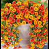 A vibrant silk morning glory vine wreath featuring bright orange and yellow flowers used for weddings and home decor.