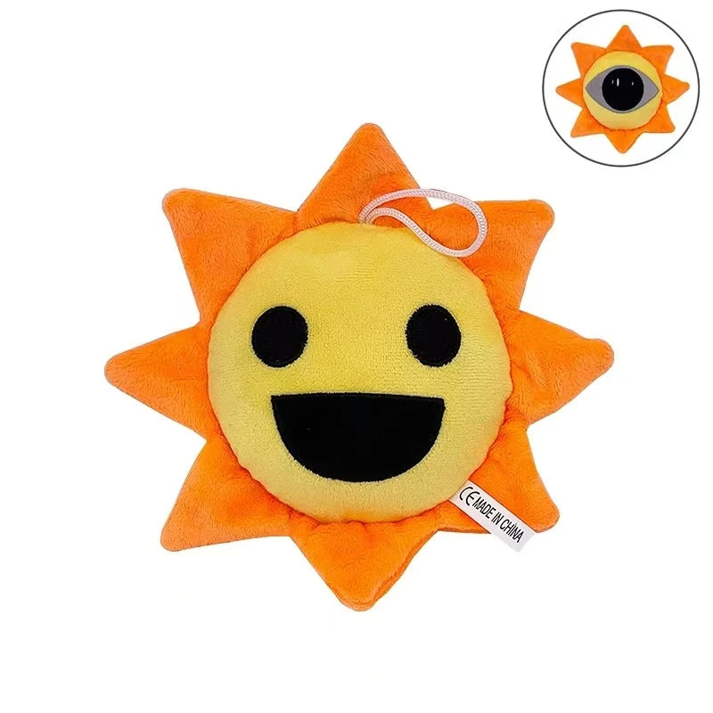 An orange sun-shaped plush toy with a yellow face and black mouth, featuring a small loop for hanging.