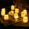 A collection of glowing warm white LED tealight candles arranged on a wooden surface with soft natural light.