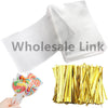 A pack of clear cellophane gift bags with gold twist ties is shown next to a hand.