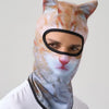 A person wearing a cat animal ski balaclava with orange and white stripes and pointed ears.