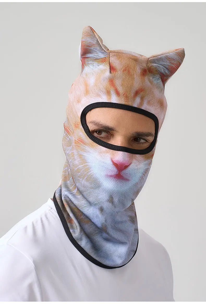 A person wearing a cat animal ski balaclava with orange and white stripes and pointed ears.