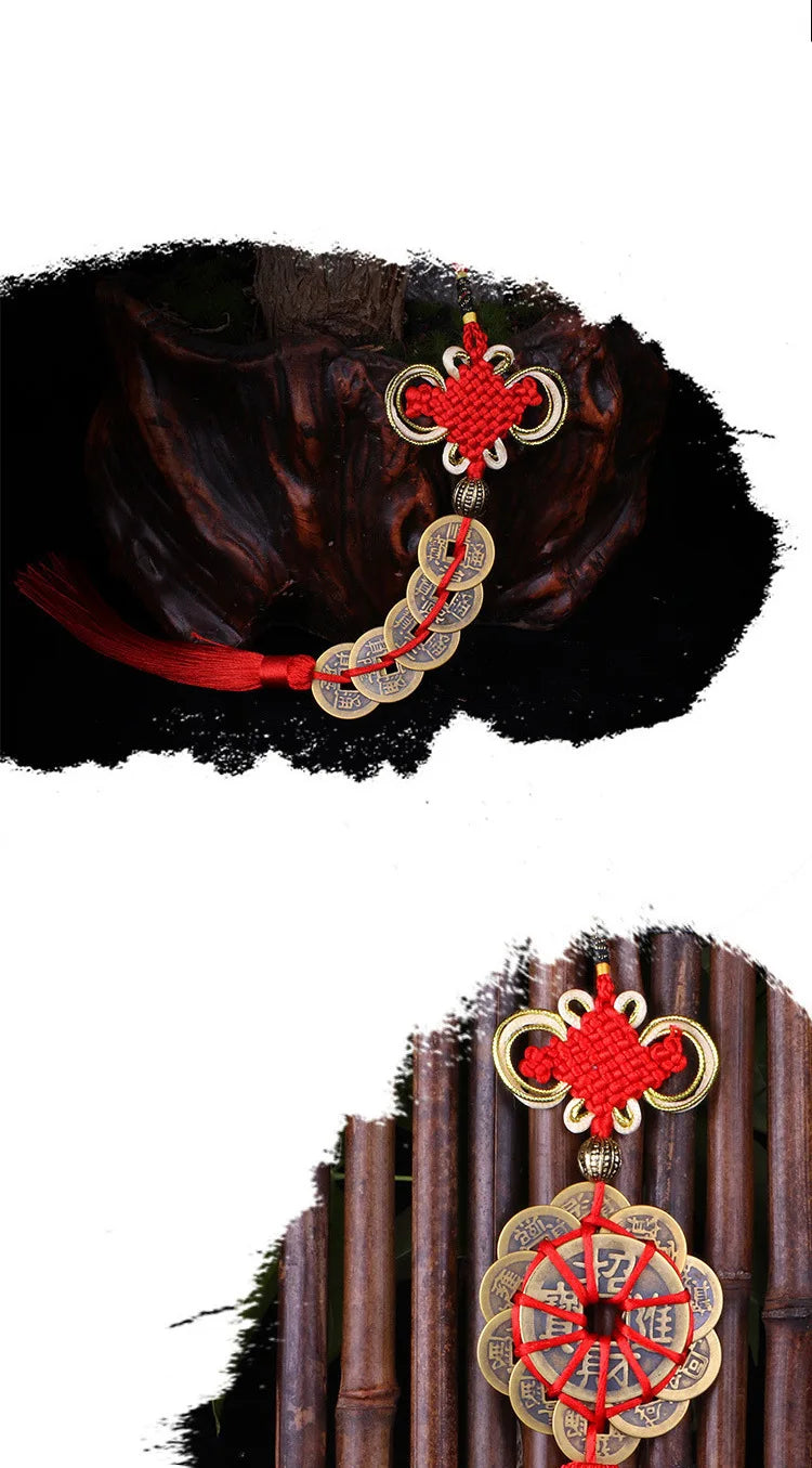 Antique copper five emperor coin pendant with a Chinese knot hanging from a red silk thread.
