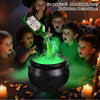 A green liquid is being poured into a black cauldron, creating fog mist in a Halloween decoration setup.