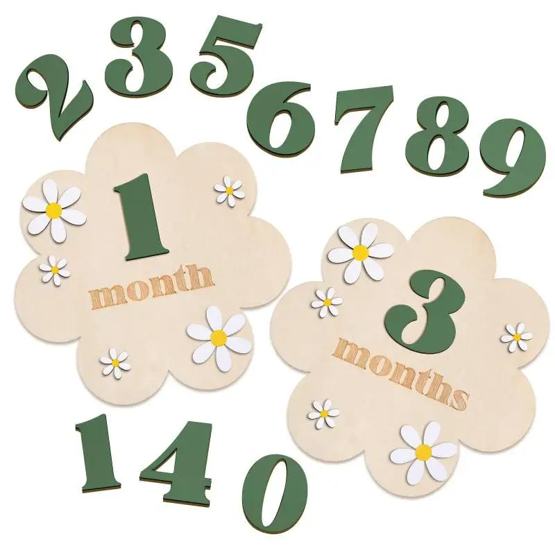 Wooden monthly milestone cards showing numbers 1 through 9 and the word month, with a large number 3 months.