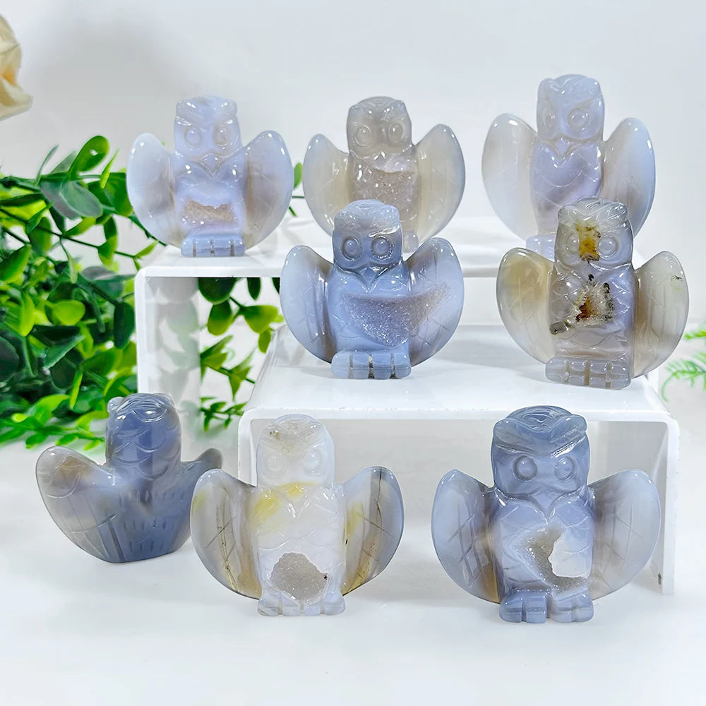 A set of natural agate crystal owl figurines in various shades of blue and translucent white.