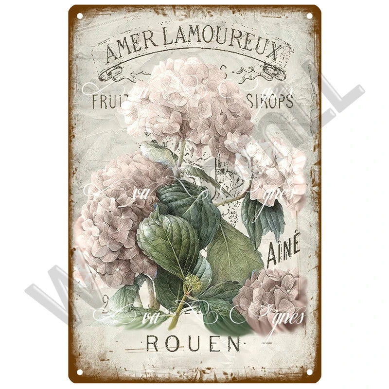 Vintage metal sign featuring text and floral illustrations with a muted pink and green color palette.