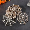 A collection of intricate wooden spider web ornaments in various sizes and shades displayed on a dark surface.