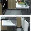 A kitchen countertop features a white wooden shelf with a black marble backsplash and a bowl of fresh vegetables.