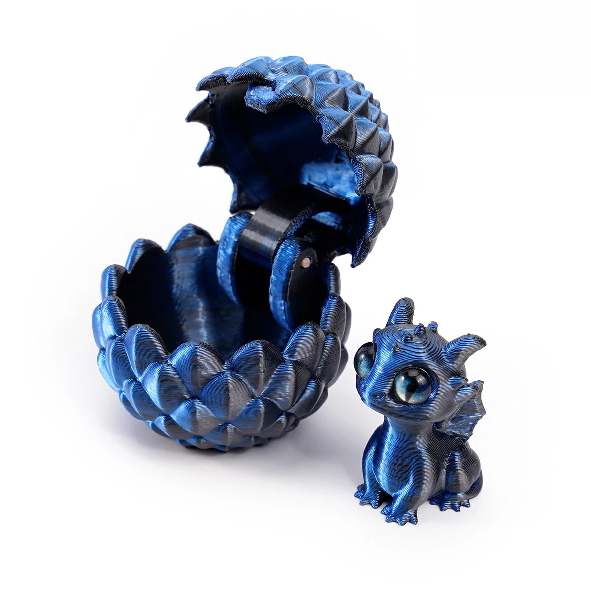 A dark blue, textured dragon egg container is open, revealing a small, blue dragon toy inside.