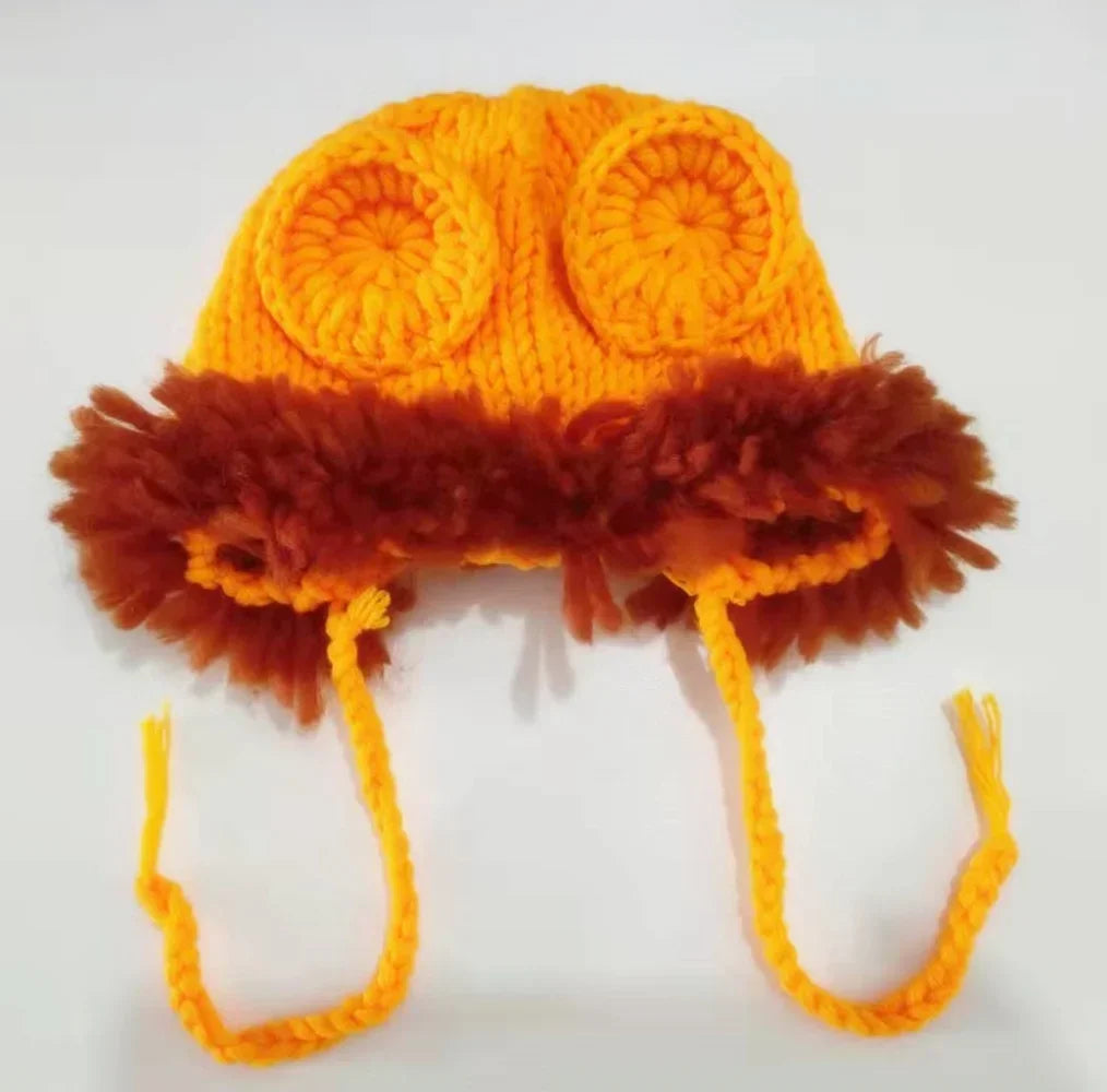 An orange handcrafted lion crochet outfit set for baby photo shoots featuring large ear details and a fluffy brown trim.