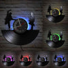 A wall clock featuring a vintage vinyl record design with silhouettes of people and a bird, illuminated by purple and blue li