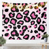 Pink leopard print tapestry wall hanging with warm string lights displayed on a white wall.