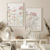 Three neutral floral wall art prints featuring soft pink and sage botanical illustrations displayed on a light-colored wall.