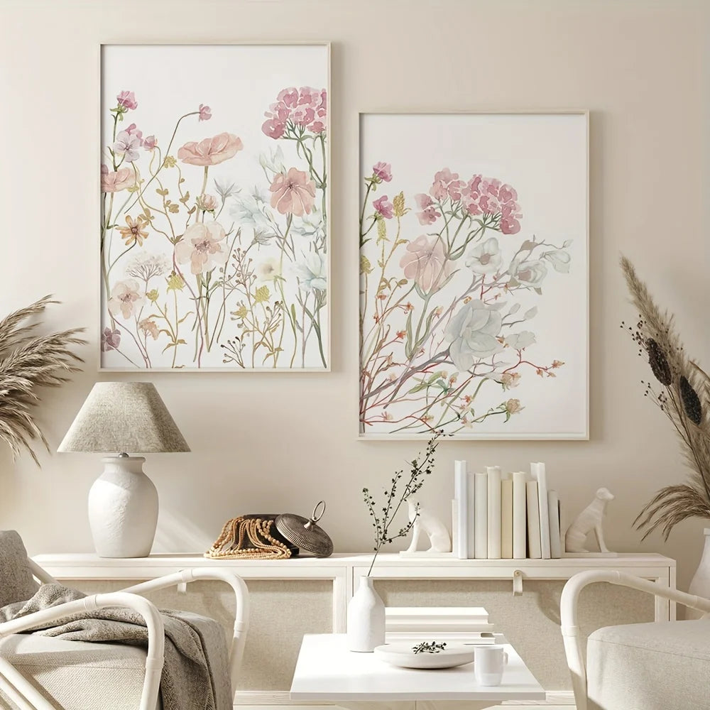 Three neutral floral wall art prints featuring soft pink and sage botanical illustrations displayed on a light-colored wall.
