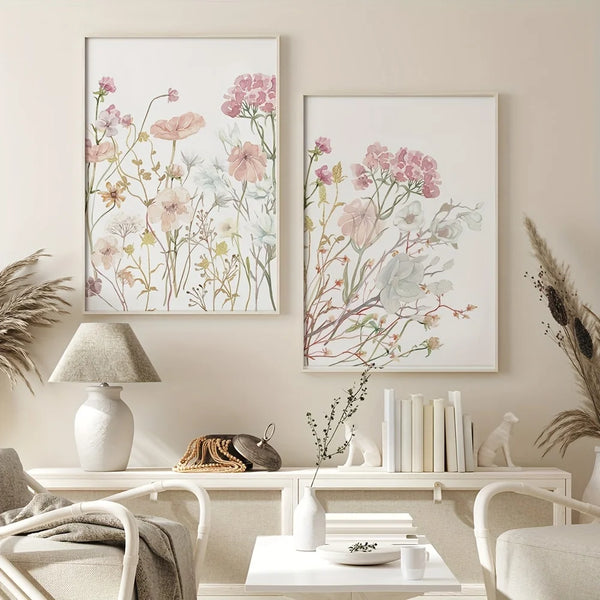 Three neutral floral wall art prints featuring soft pink and sage botanical illustrations displayed on a light-colored wall.