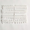 A white wooden message board with various letters and symbols carved into it.