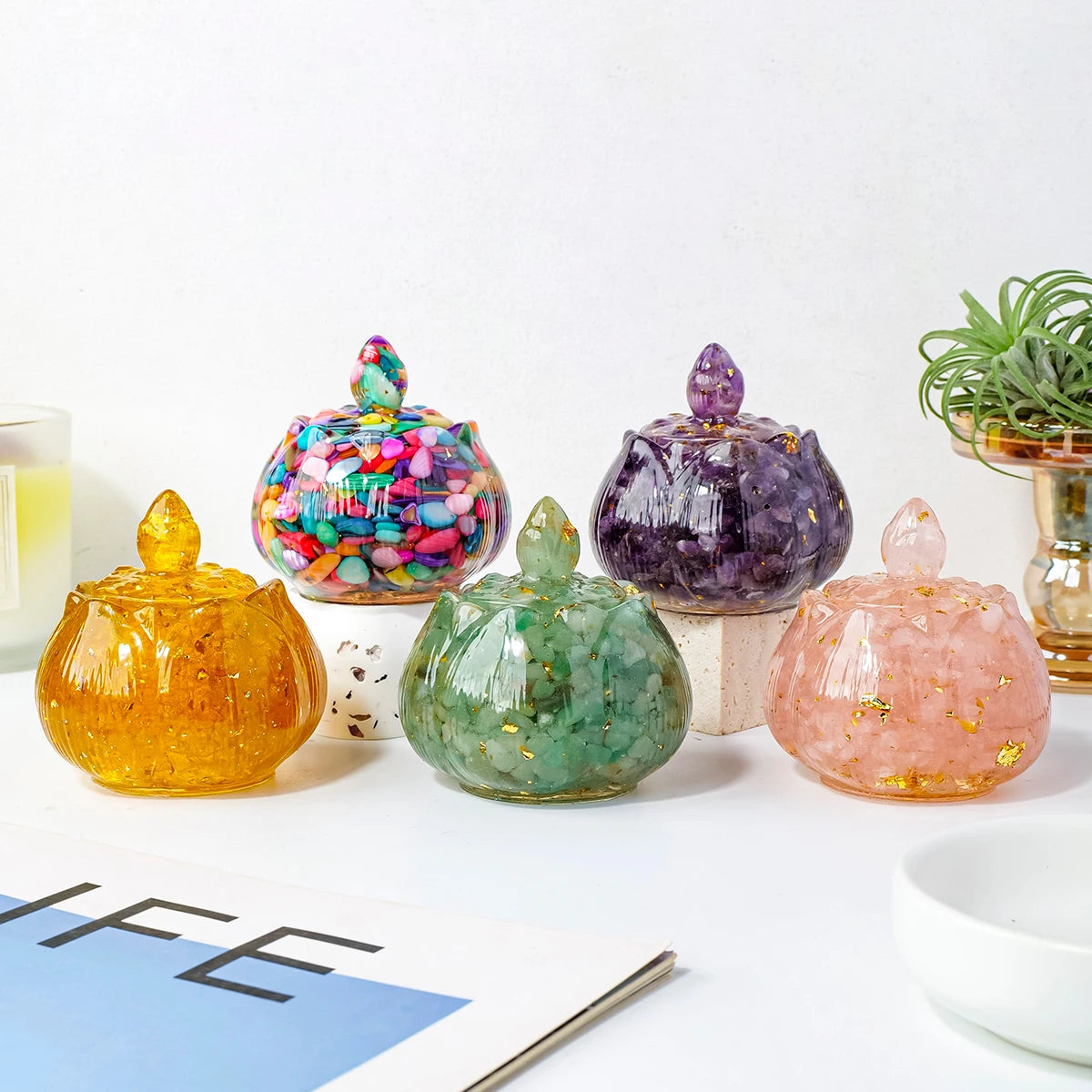 A collection of seven natural crystal bowls in various colors and shapes displayed on a white surface.