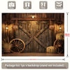 A rustic wooden cowboy backdrop featuring a large wooden door and decorative elements like wagon wheels and hay.