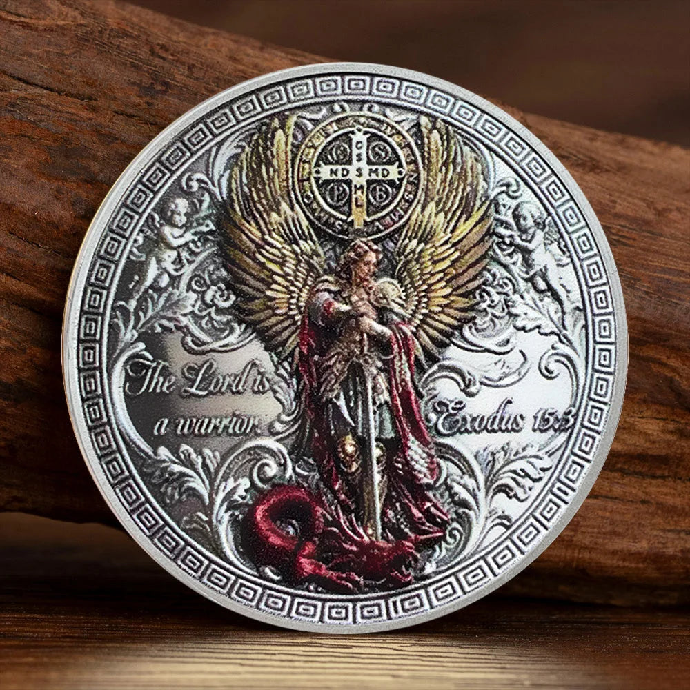 A commemorative coin featuring Saint Michael the Archangel with wings and a sword, set against a decorative border.