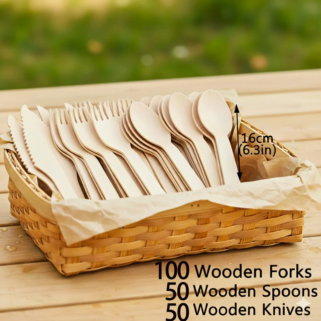 A wooden cutlery set featuring 100 forks, 50 spoons, and 50 knives displayed in a woven basket on a wooden surface.