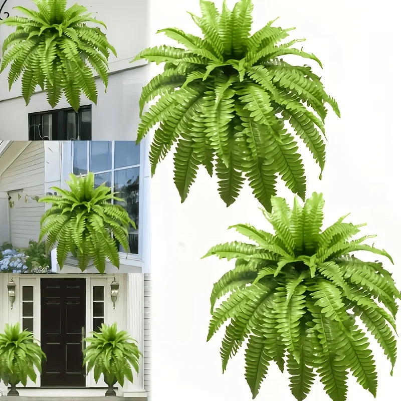 Two large artificial Boston ferns displayed against a white exterior wall.