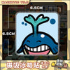 A blue and white acrylic fridge magnet featuring a stylized, smiling sea creature.