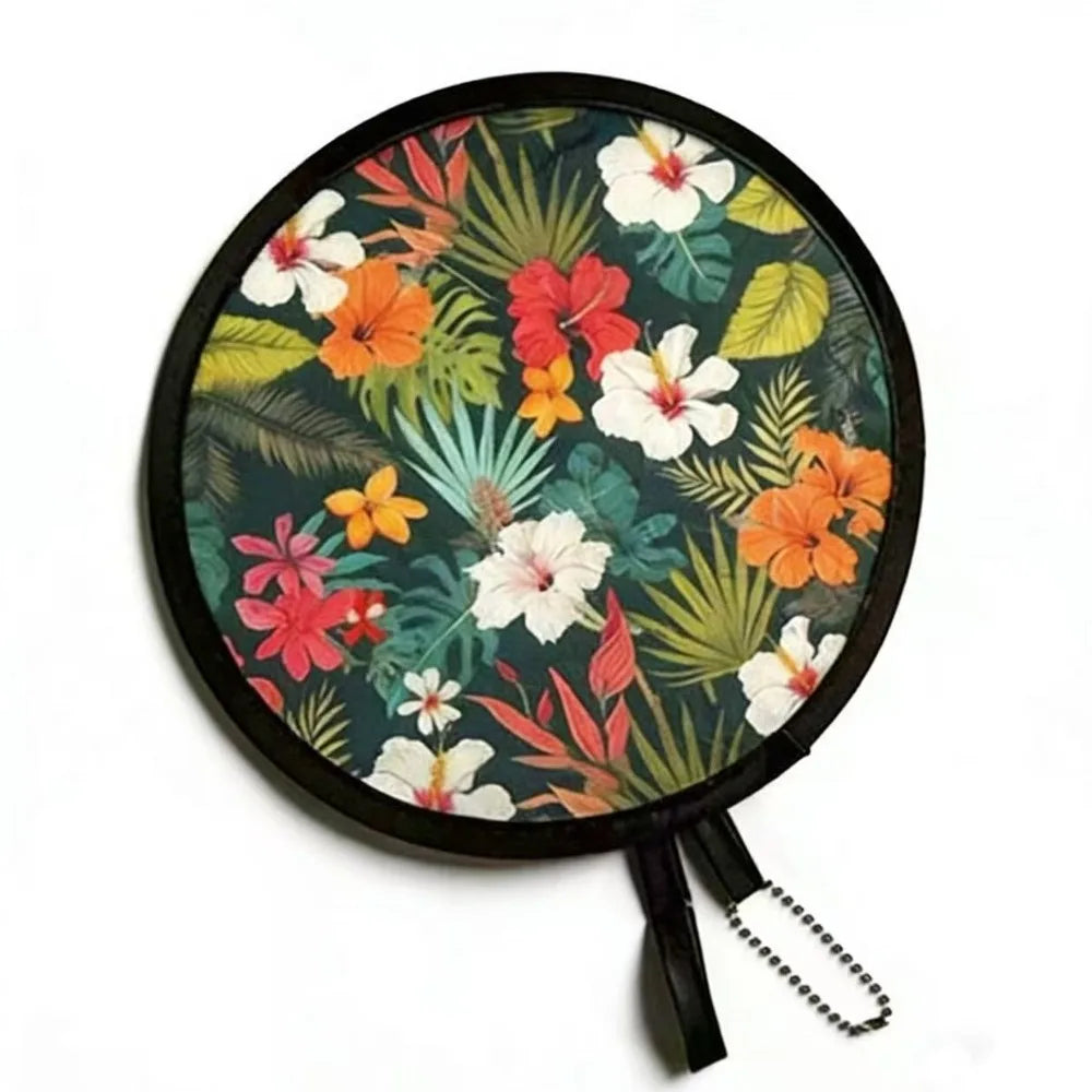 A round fabric fan featuring a vibrant floral pattern of orange, red, and white flowers on a dark green background.