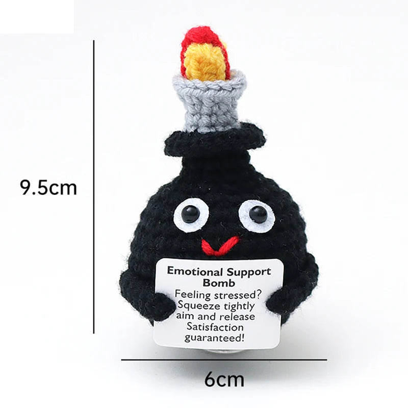 Black crochet potato doll with a red and yellow hat and an inspirational support card