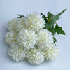 A bouquet of artificial white hydrangea and camellia flowers with green leaves.