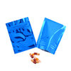 Two bright blue foil zip bags containing several small pills or tablets.