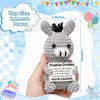 A handmade crochet positive donkey ornament in gray is held in a hand against a light blue background.