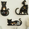 A black cat wall shelf featuring a silhouette of a cat with a crescent moon, holding candles and crystals.