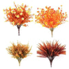 A bouquet of artificial fall flowers featuring vibrant orange and yellow foliage for home decor