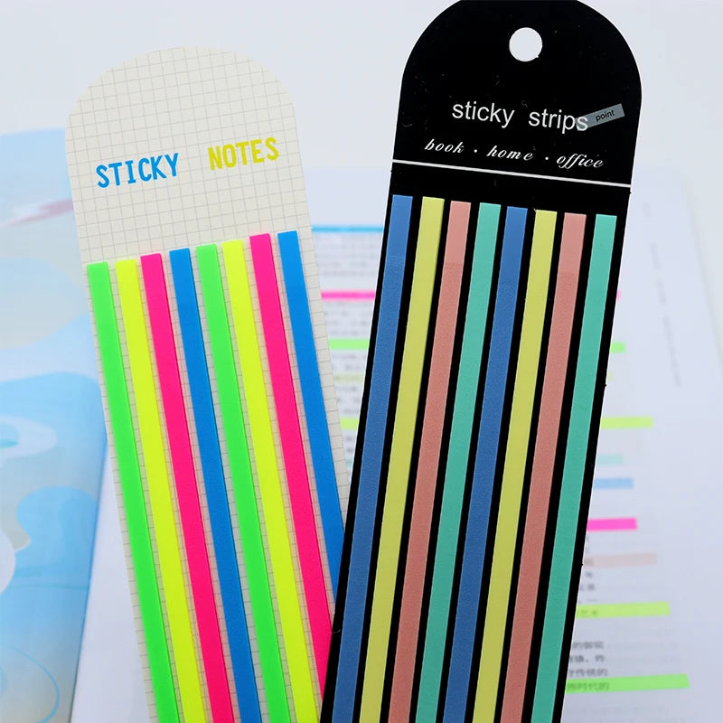 A set of sticky strips with various colored index tabs and a black tag for book home office use.