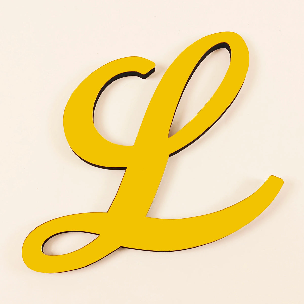 A bright yellow 3D acrylic letter L wall sticker with a black outline.