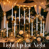 Elegant candlelight display featuring tall taper candles and glowing lanterns set on a wooden table.