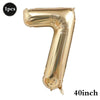 A large, gold foil number balloon shaped like the digit 7.