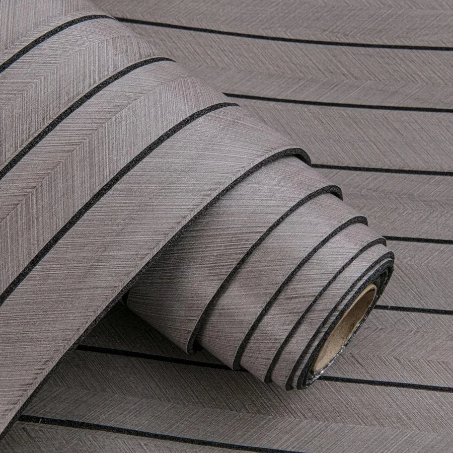 Roll of self-adhesive 3D wood grain wall panels in gray with black accent lines