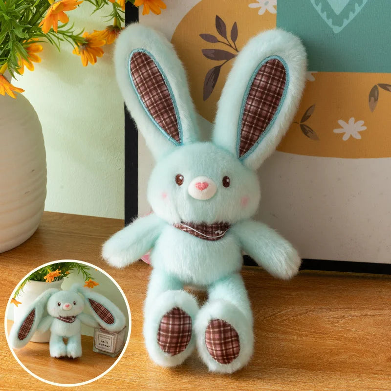 A light blue giant kawaii rabbit plush toy with pink nose and brown ear accents sitting on a wooden surface.