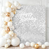 A white and gold sequin wall backdrop featuring a Happy Birthday message on a silver glitter background.